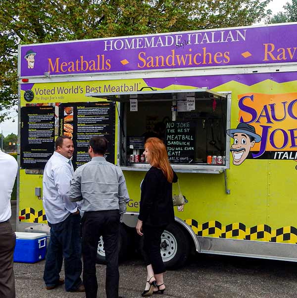 Employees at company event ordering from food truck