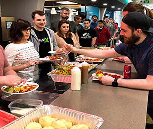 Company staff enjoying indoor lunch service