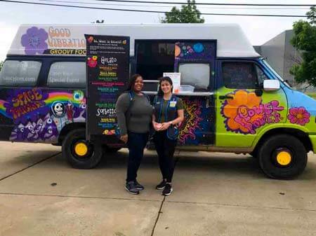 Two employees standing in front of gelato truck at company Food Truck event
