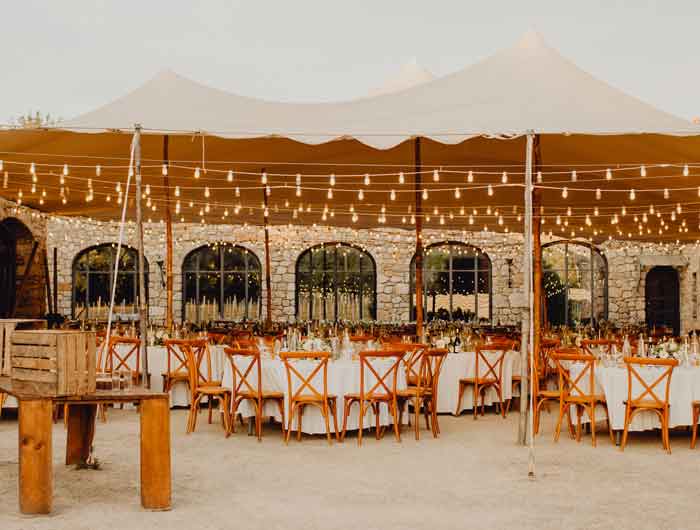 Full wedding set up with tents, chairs, and lights