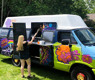 Girl getting ice cream from groovy dessert truck at her graduation party