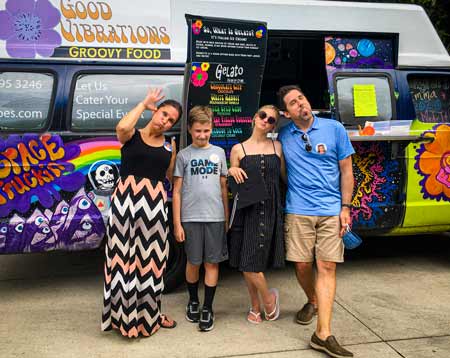Family with graduate having fun in front of Good Vibrations Groovy Gelato Truck