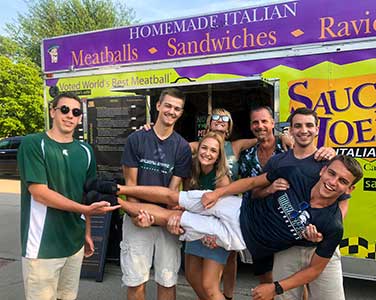 People having fun at graduation party with food truck