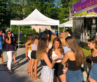 People having fun at graduation party with food truck