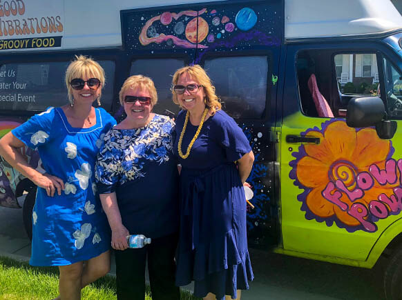 Ladies smiling in front of gelato truck