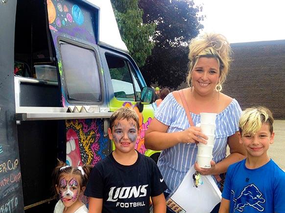 Happy mom and kids getting ice cream