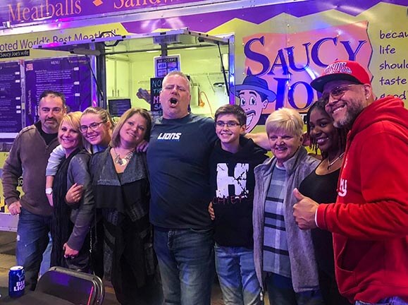 Family having fun in front of food truck