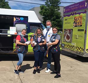 employer with employees in front of food truck